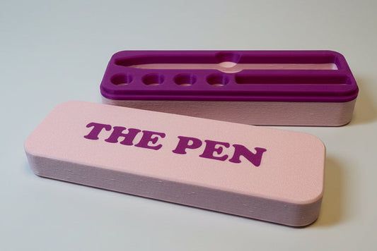 Pink and purple KwikPen case with 'THE PEN' engraving in a purple on pink background