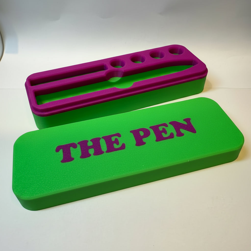 green and purple KwikPen case with 'THE PEN' engraving in a purple on green background